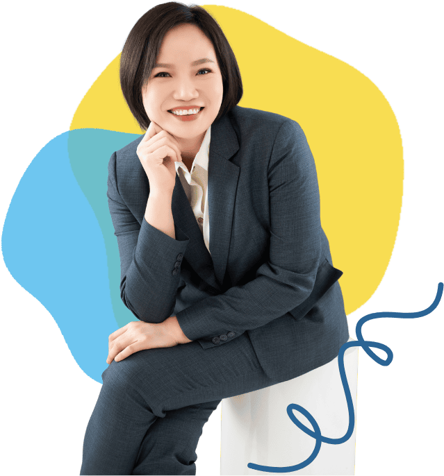 Professional woman in business attire smiling, representing speech therapy services.