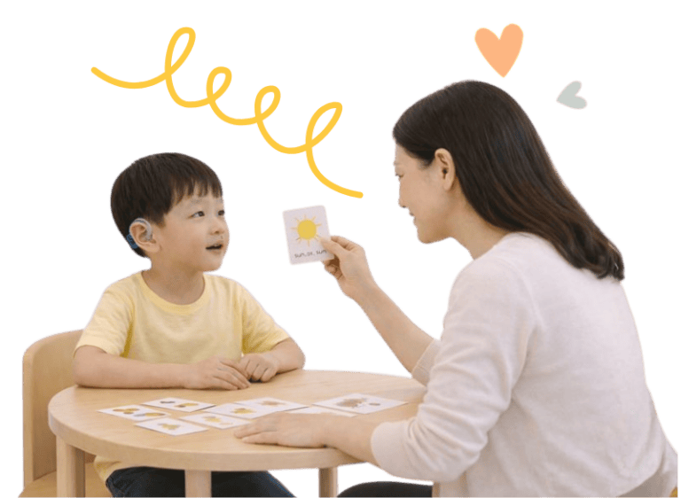 Child receiving speech therapy for hearing loss from therapist.